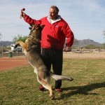 A man and his dog playing with a frisbee.