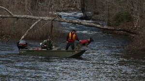 A man and his dog are in the water.