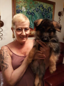 A woman holding a dog in her arms.