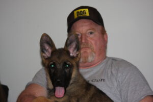 A man and his dog are posing for the camera.