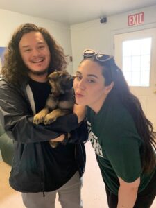 A man and woman holding a baby bear.