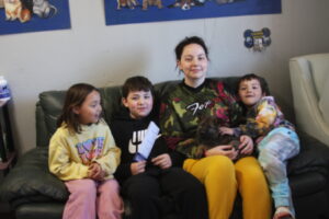 A group of children sitting on top of a couch.
